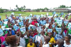 primary school students as they received notebooks for the ovu foundation emplowerment